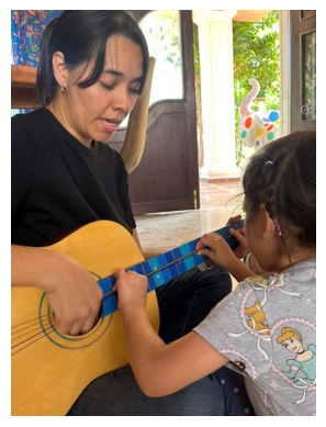 Teacher guiding a guitar lesson at Colossal Academy Primary